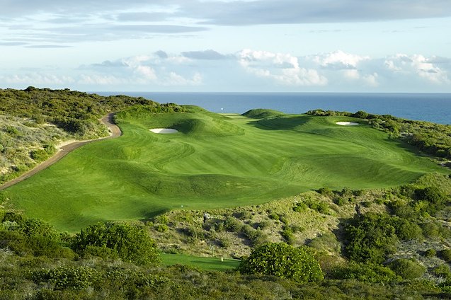 Coastal golf course fairway and green above the sea