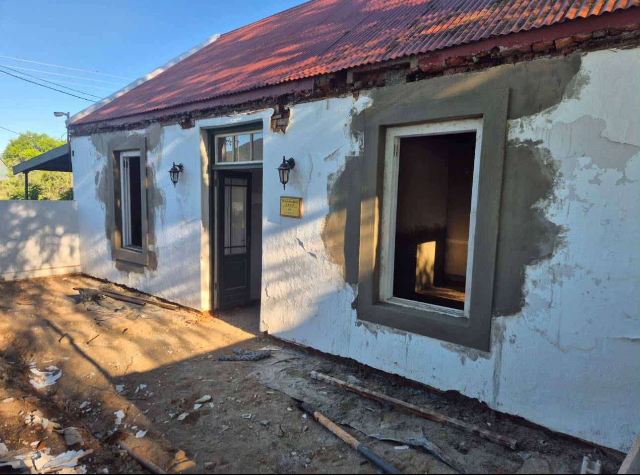 Cottage exterior being replastered around new window frames